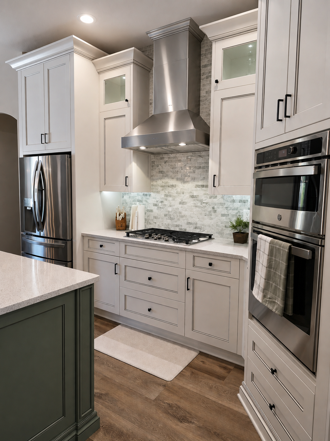 Two-tone kitchen with light perimeter cabinets and a dark island